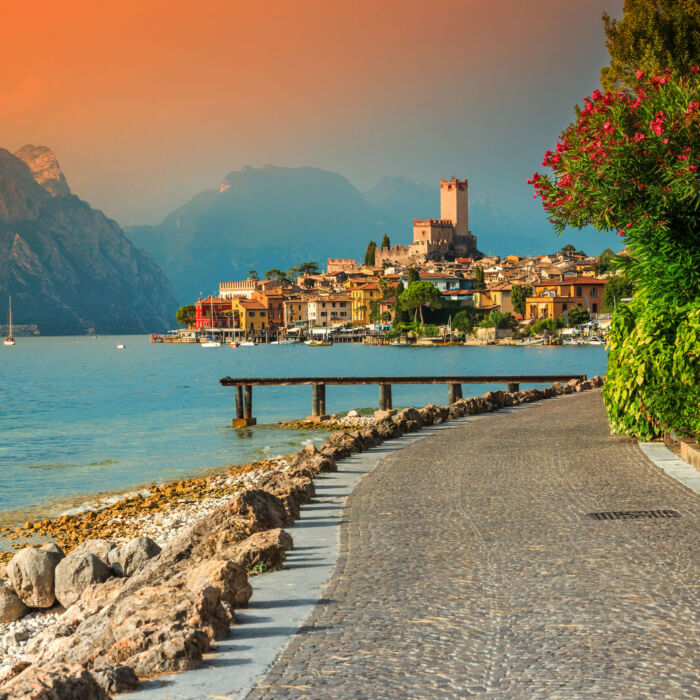 Fantastic Malcesine tourist resort and colorful sunset, Garda lake, Italy