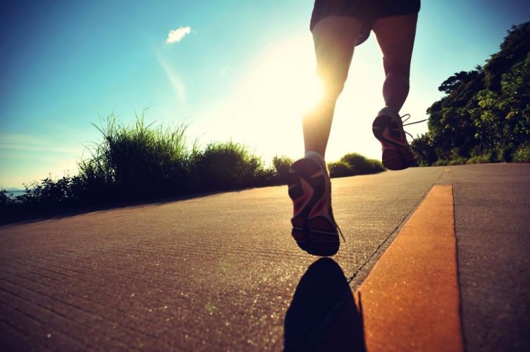 young fitness woman running on sunrise seaside trail